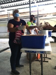 Laura Nunez hands out meals for those in need. 