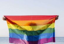 Going On Vacation Just Got Easier gay flag on beach