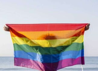 Going On Vacation Just Got Easier gay flag on beach