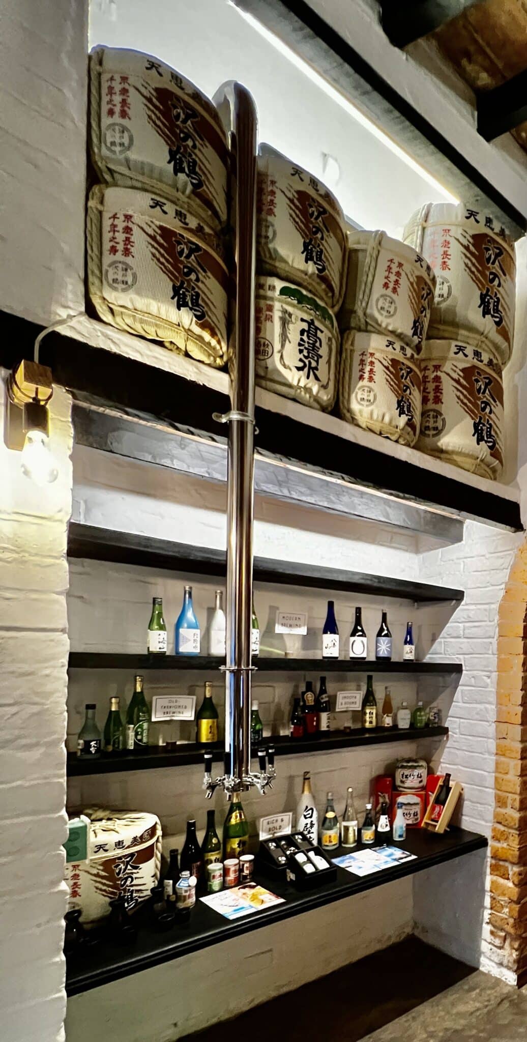 A custom made draft beer dispenser and sake display.