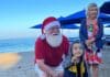 Christmas on the Beach, Puerto Vallarta Style A long-held tradition continued this Christmas morning on the beach in front of Blue Chairs Bar, Restaurant and Hotel. John Ramsey captured these happy smiles as children got to pick a Christmas gift hanging from the palm trees.