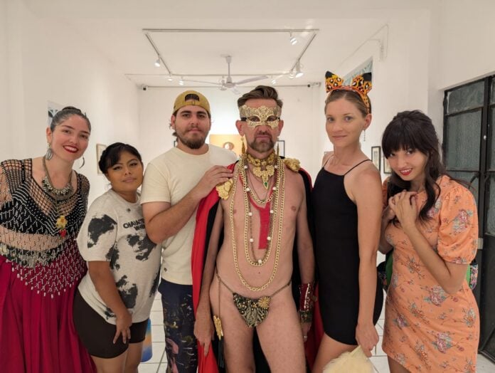 Felix d'Eon is flanked by his models from the fashion show.