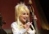 Dolly Parton, Country Music Icon and Beloved LGBTQ+ Ally, Dies at 80 Country star Dolly Parton sings on stage during a Grand Ole Opry live broadcast in Nashville, Tenn., April 23, 2005, as U.S. soldiers watch the show via a video feed in Iraq. Photo via Wikimedia Commons.