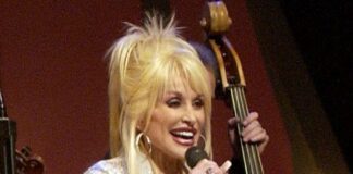 Dolly Parton, Country Music Icon and Beloved LGBTQ+ Ally, Dies at 80 Country star Dolly Parton sings on stage during a Grand Ole Opry live broadcast in Nashville, Tenn., April 23, 2005, as U.S. soldiers watch the show via a video feed in Iraq. Photo via Wikimedia Commons.