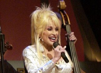 Dolly Parton, Country Music Icon and Beloved LGBTQ+ Ally, Dies at 80 Country star Dolly Parton sings on stage during a Grand Ole Opry live broadcast in Nashville, Tenn., April 23, 2005, as U.S. soldiers watch the show via a video feed in Iraq. Photo via Wikimedia Commons.